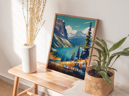 A framed Grinnell Glacier Trail poster sits on a wooden bench beside a white vase with dried stems and a potted plant, against a softly lit wall.