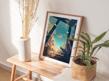 A framed poster of Dry Tortugas National Park leans against a wall on a wooden bench, accompanied by a white vase with dried flowers and a potted green plant.