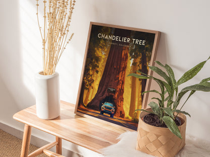 A framed Chandelier Tree poster rests on a wooden bench, accompanied by a white vase with dried flowers and a potted green plant. Soft sunlight illuminates the scene.