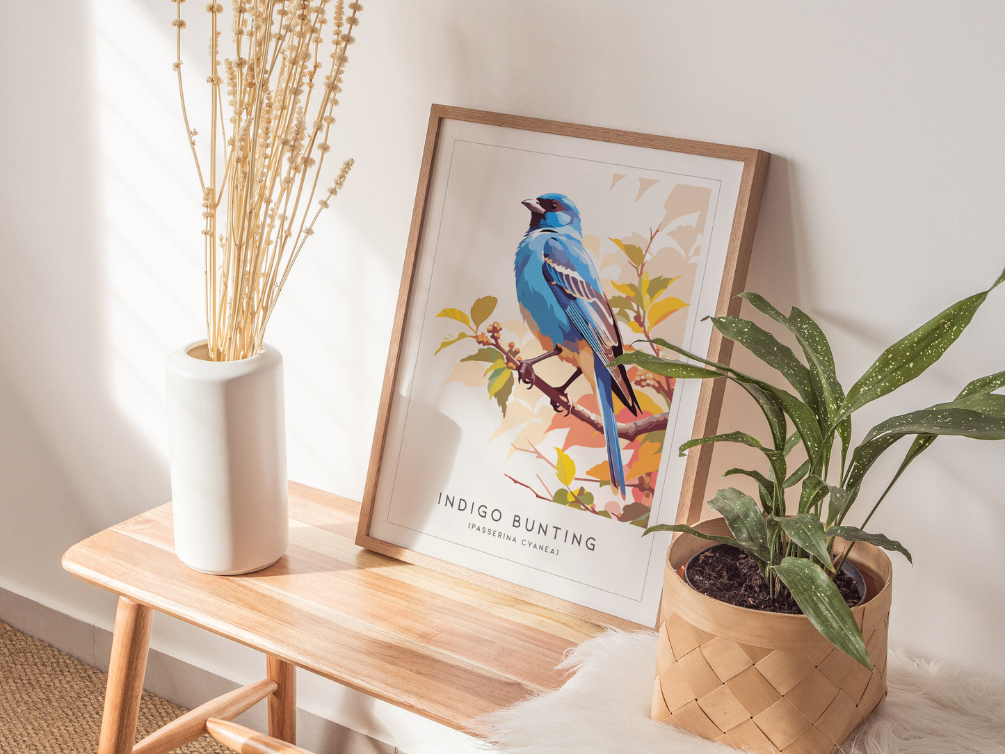 Framed Indigo Bunting art print featuring vibrant blue bird perched on a branch with colorful autumn leaves, perfect wildlife decor.