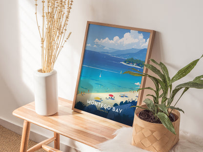 A Montego Bay poster with vibrant blue waters and sandy beach is displayed on a wooden bench, alongside a white vase with dried flowers and a potted plant.