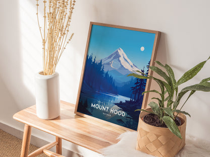 A framed Mount Hood poster sits on a wooden bench, surrounded by a white vase with dried flowers and a potted plant in a woven basket.