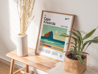 A framed Cape Kiwanda poster rests on a wooden bench, accompanied by a white vase with dried flowers and a potted plant.