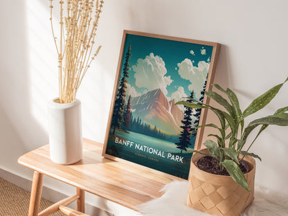 A framed Banff National Park poster rests on a wooden bench, adorned with a potted plant and a vase of dried flowers, creating a cozy, nature-inspired setting.