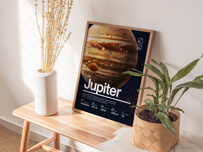 A framed poster of Jupiter with detailed planetary features is displayed on a wooden bench, alongside a white vase with dried plants and a potted green plant.