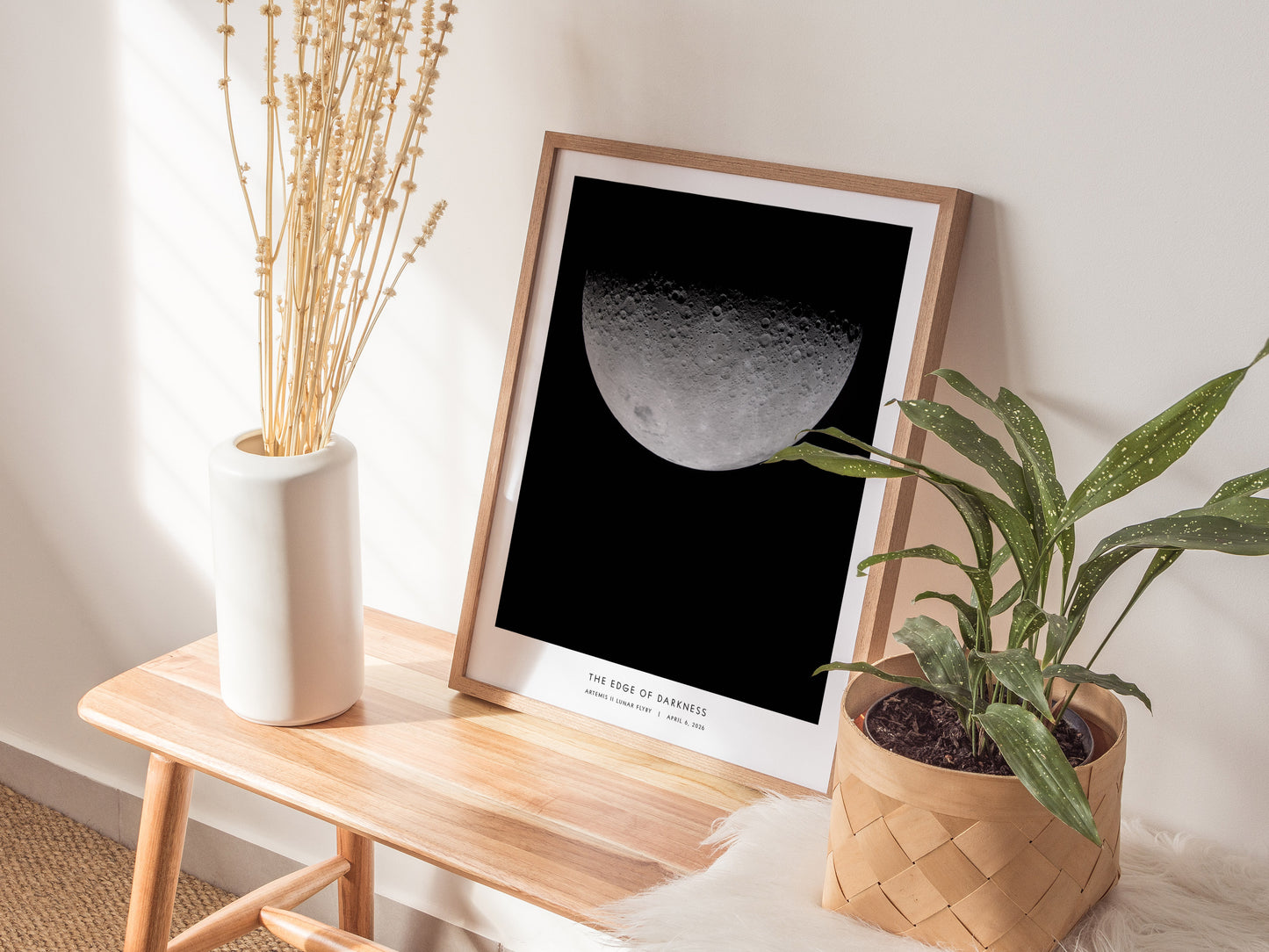 Framed photographic print of the moon's craters in high contrast, titled "Edge of Darkness," showcasing lunar textures, perfect for space art lovers.