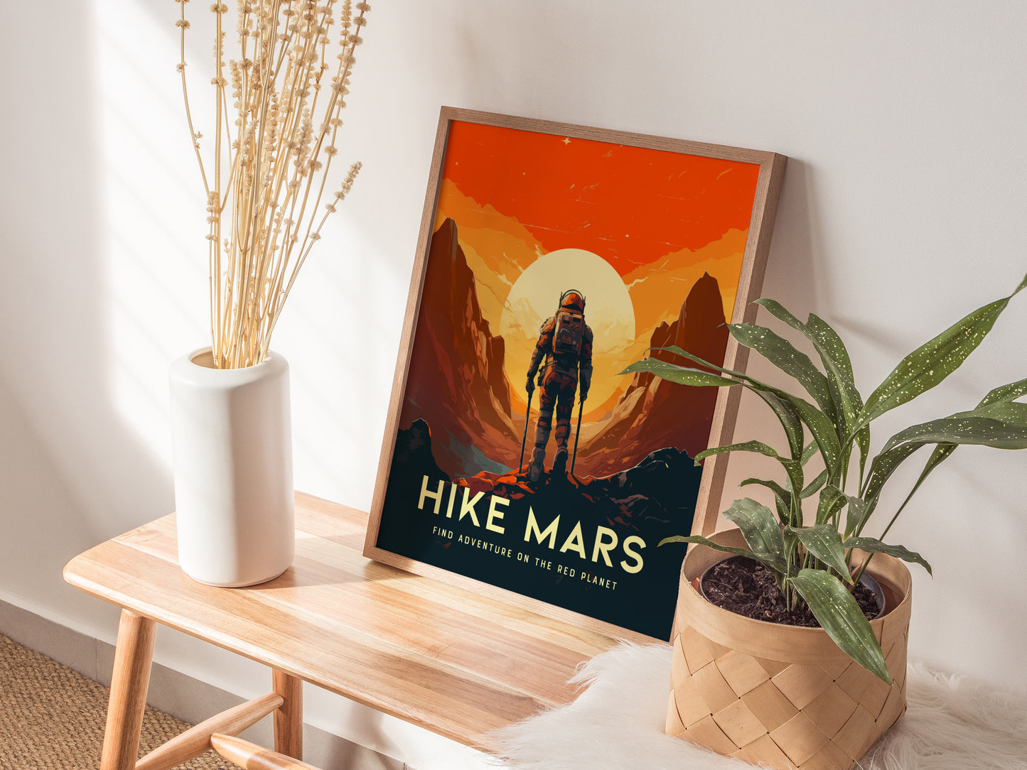 A Mars-themed poster with an astronaut exploring stylized Martian landscapes is propped on a wooden bench, surrounded by a white vase with dried flowers and a potted plant.