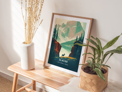 A framed Glacier National Park poster with a minimalist design sits on a wooden bench, accompanied by a white vase with dried flowers and a leafy potted plant.