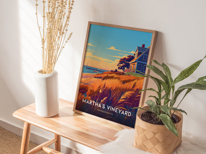 A framed Martha’s Vineyard poster rests on a wooden bench beside a white vase with dried flowers and a potted plant, creating a cozy and inviting interior setting.