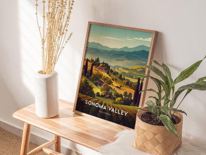 A framed Sonoma Valley poster showcasing vineyard hills is placed on a wooden bench, accompanied by a white vase with dried flowers and a potted plant.