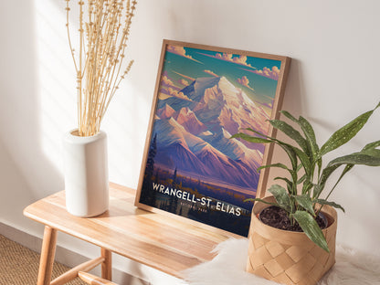 A framed Wrangell-St. Elias National Park poster featuring colorful mountain art rests on a wooden bench beside a white vase with dried flowers and a potted green plant.
