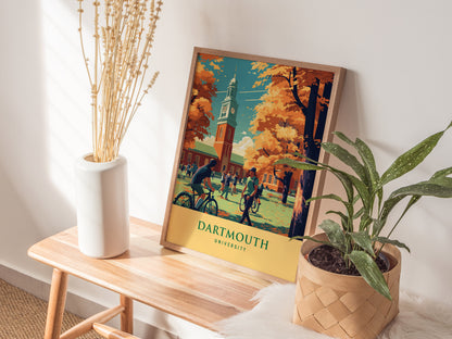 A Dartmouth University poster featuring students and autumn trees is displayed on a wooden bench, accompanied by a white vase with dried plants and a potted green plant.