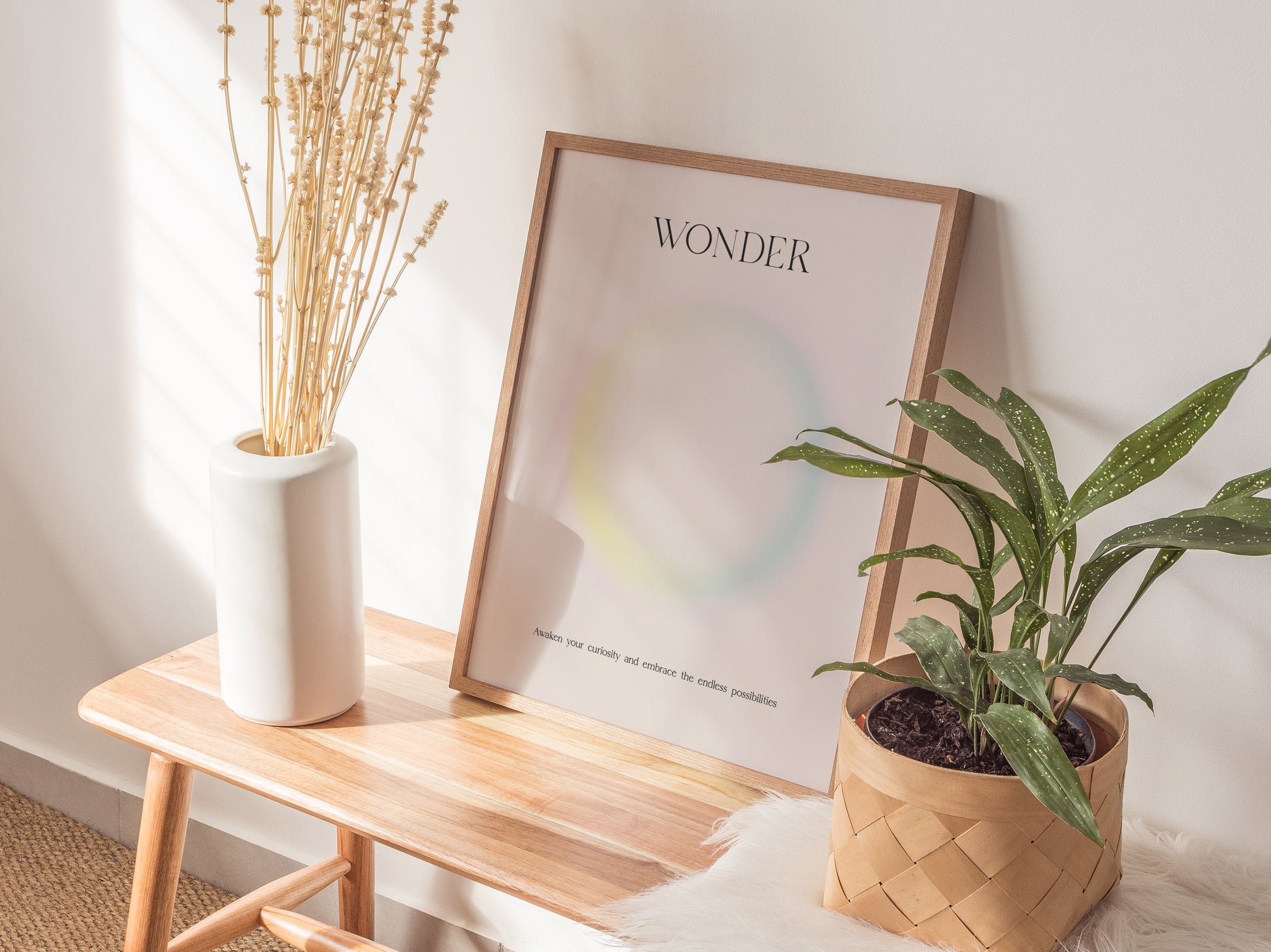 Framed WONDER wall art print with pastel gradient design, featuring soft yellow, pink, and blue hues on beige background, perfect for travel art decor.