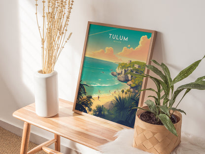 A framed poster of Tulum, Mexico, featuring Mayan ruins and turquoise waters, rests on a wooden bench beside a white vase and a potted plant.