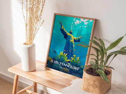 A framed John Pennekamp Coral Reef State Park poster rests on a wooden bench next to a white vase with dried flowers and a potted green plant.
