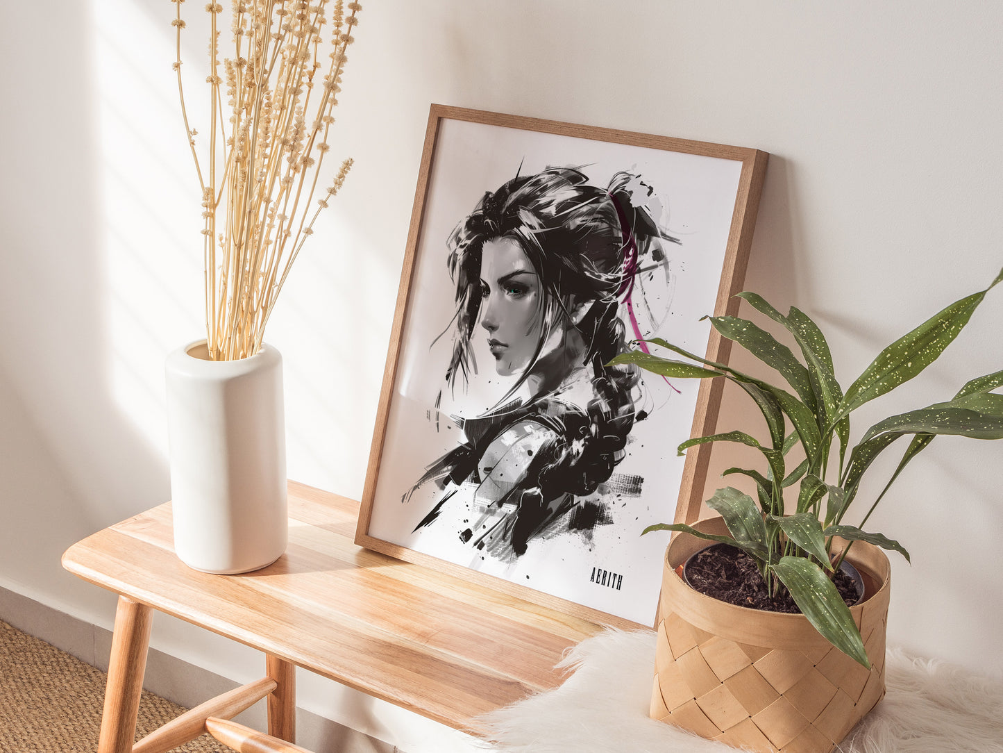 A framed monochrome portrait of a woman with braided hair leans against a wall on a wooden bench, accompanied by a white vase with dried flowers and a potted plant.