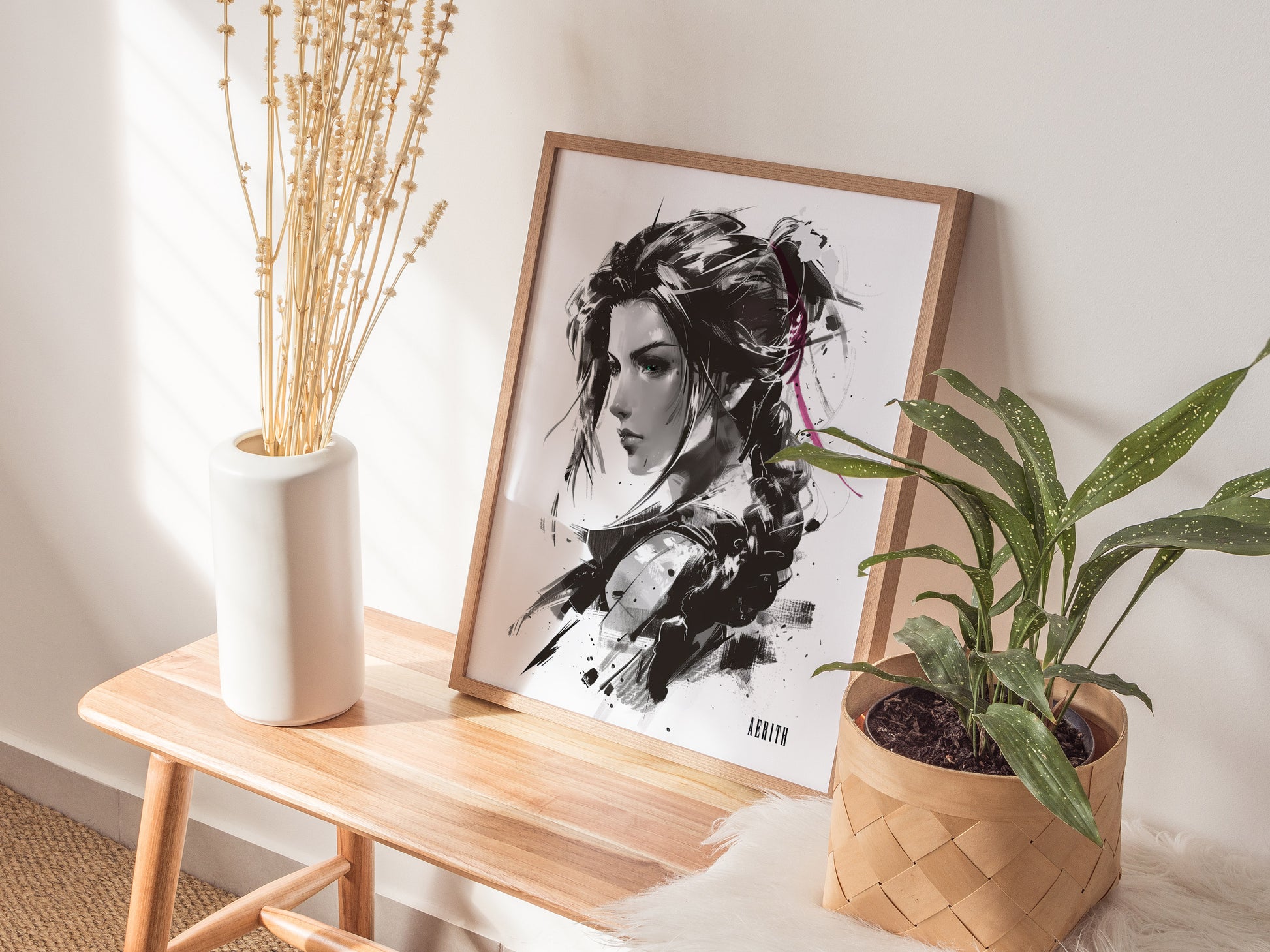 A framed monochrome portrait of a woman with braided hair leans against a wall on a wooden bench, accompanied by a white vase with dried flowers and a potted plant.