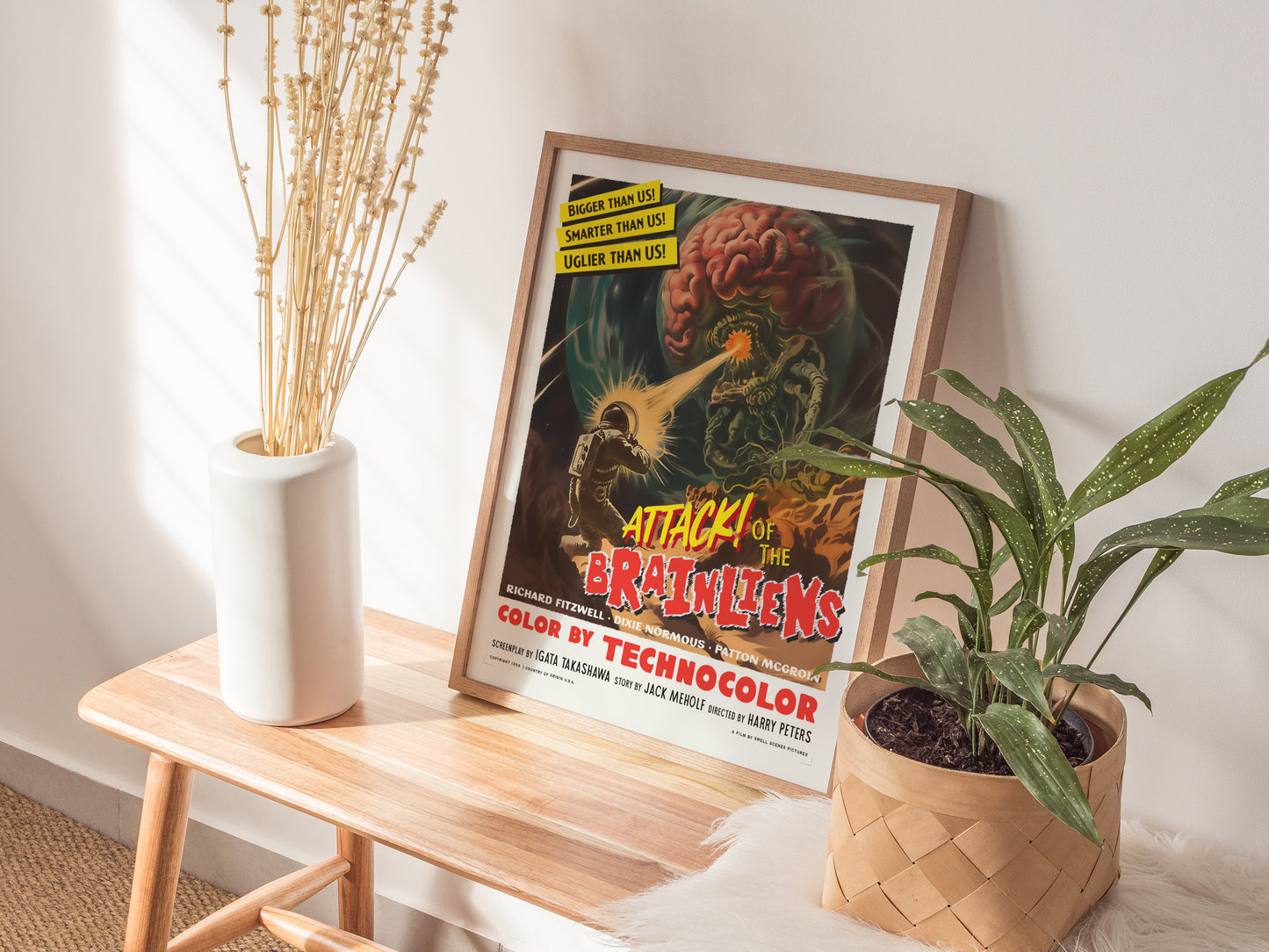 Home setting displaying framed and unframed wall art posters illustrating chaotic alien invasion scenes from a retro