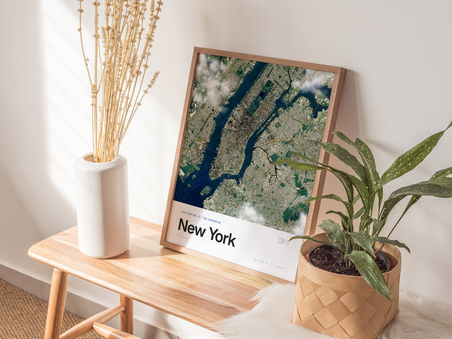 Framed satellite view of New York City showcasing Manhattan's urban grid, lush parks, and blue rivers in a modern design.