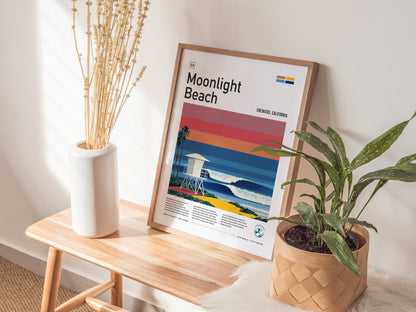 Framed Moonlight Beach poster featuring vibrant sunset colors, lifeguard tower, and ocean waves, perfect surf art for decor.