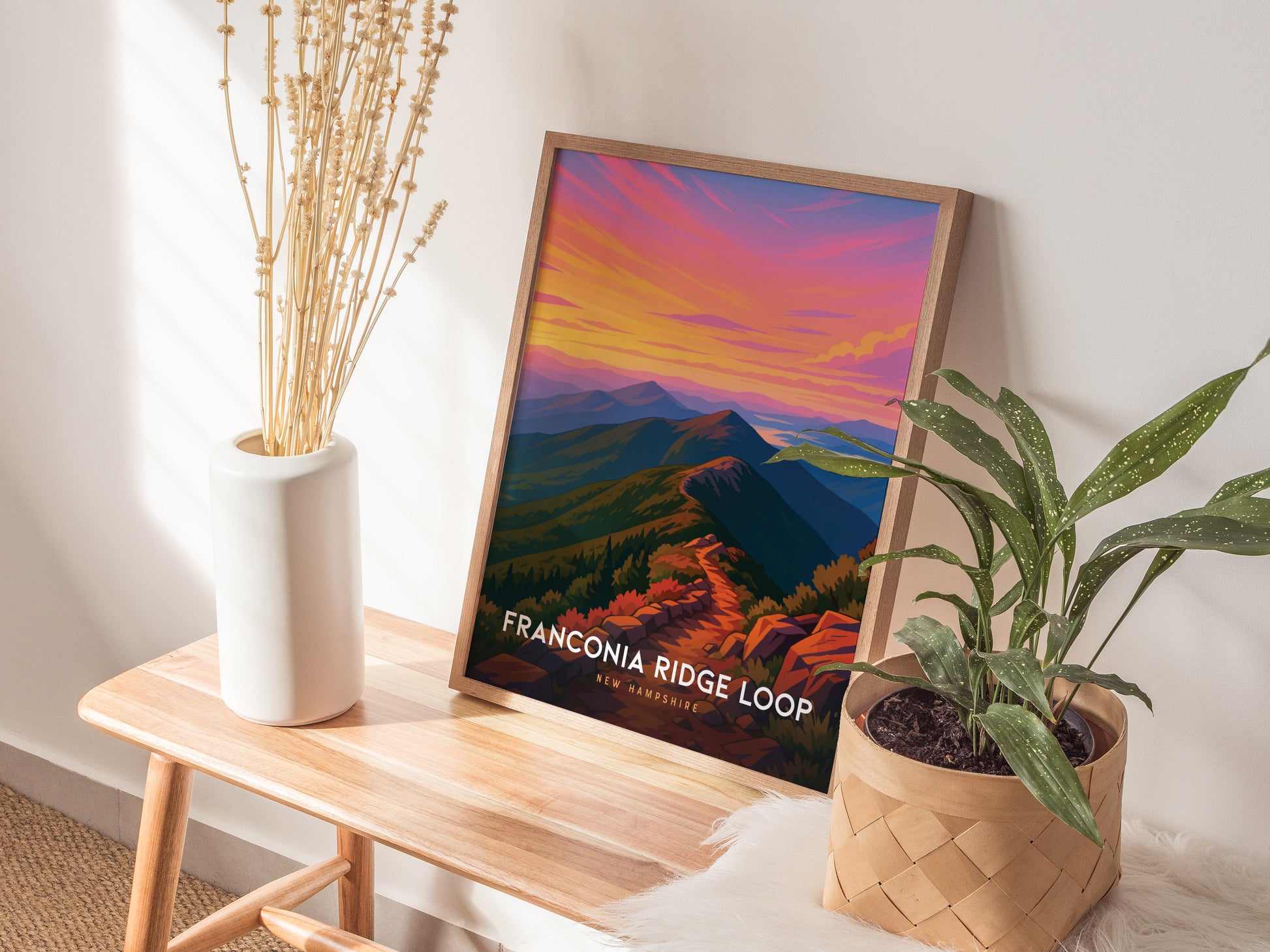 Scenic Franconia Ridge Loop art print featuring vibrant sunrise colors, a winding trail, and stylized mountain ranges by Swell Scenes.