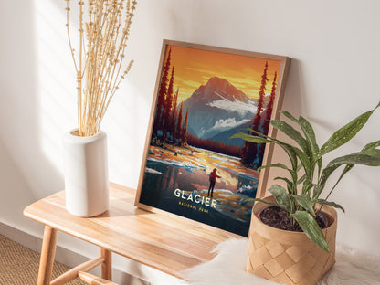 A framed Glacier National Park poster rests on a wooden bench beside a white vase with dried flowers and a potted green plant, creating a cozy, nature-inspired setting.