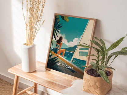 A framed St. Thomas poster in a retro travel style sits on a wooden bench, flanked by a white vase with dried flowers and a potted plant.