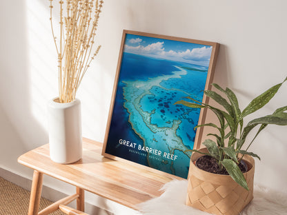 A framed Great Barrier Reef poster rests on a wooden bench, accompanied by a white vase with dried flowers and a potted green plant, creating a serene decor setting.