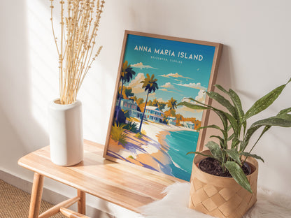 A wooden bench holds a framed Anna Maria Island poster depicting a colorful beach scene with palm trees. Beside it, a white vase with tall dried stems and a woven basket with a green plant add a natural touch.