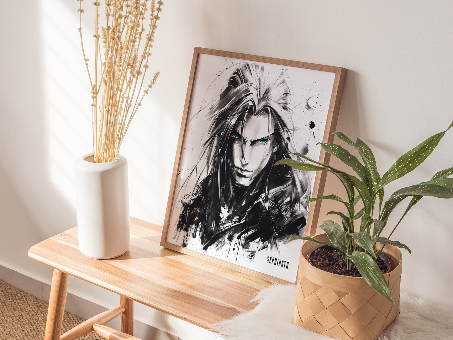 A framed black and white poster of a character with long hair and intense eyes is displayed on a wooden table, accompanied by a white vase and a potted plant.