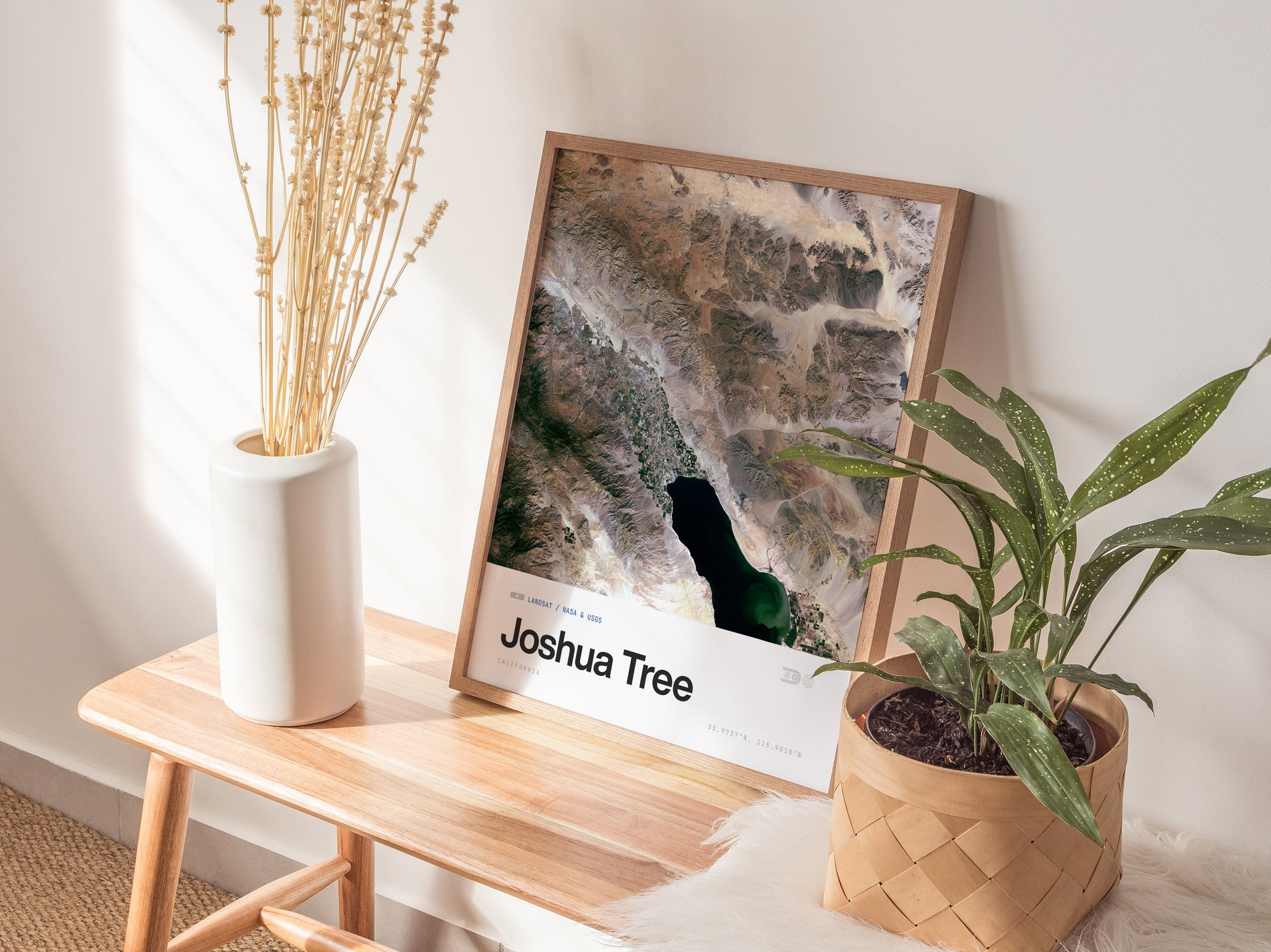 Framed satellite print of Joshua Tree's desert landscape, showcasing earthy tones, unique land formations, and a body of water.