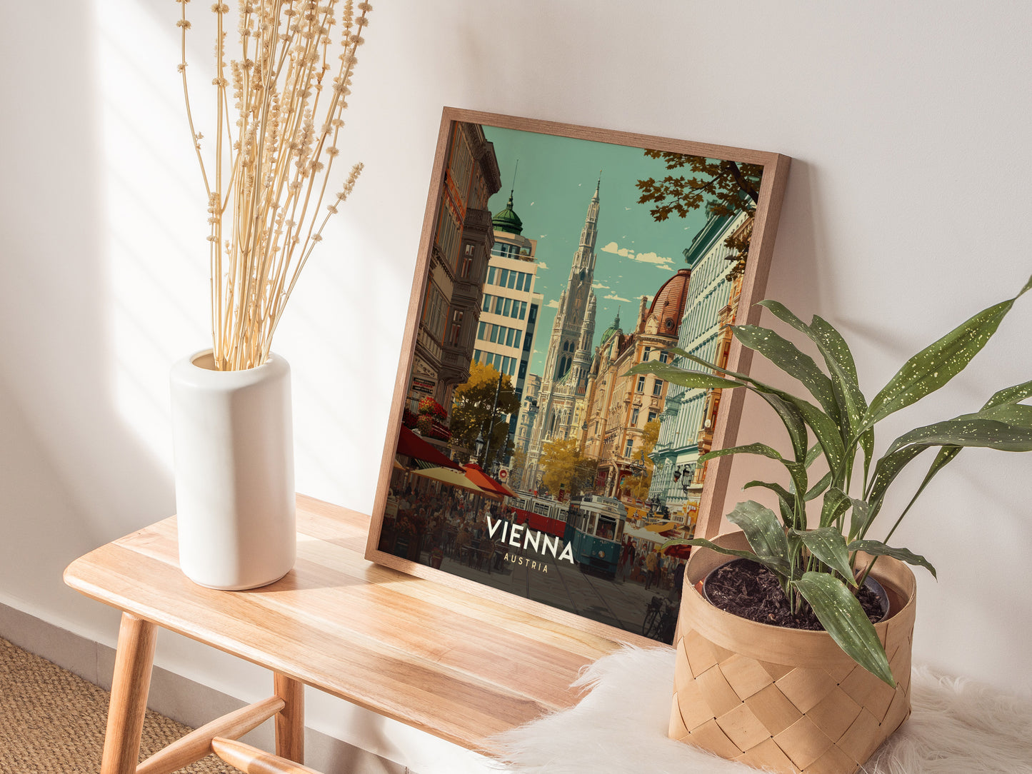 Framed Vienna cityscape poster featuring a historic tower, lively street cafes, and a tram in warm pastel colors, perfect travel art.
