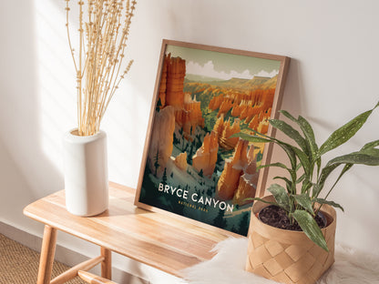 A framed Bryce Canyon National Park print rests on a wooden bench beside a white vase with dried flowers and a potted green plant, all bathed in natural sunlight.