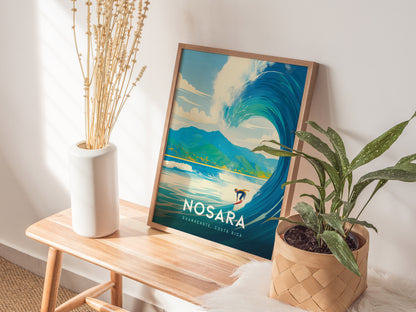 A framed Nosara Costa Rica poster featuring a surfer riding a large wave is placed on a wooden bench next to a white vase with dried flowers and a potted.