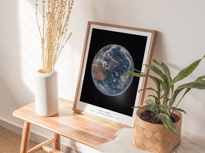 Framed poster of Earth from space, showcasing vibrant blues, greens, and whites against a black background, perfect for space art enthusiasts.