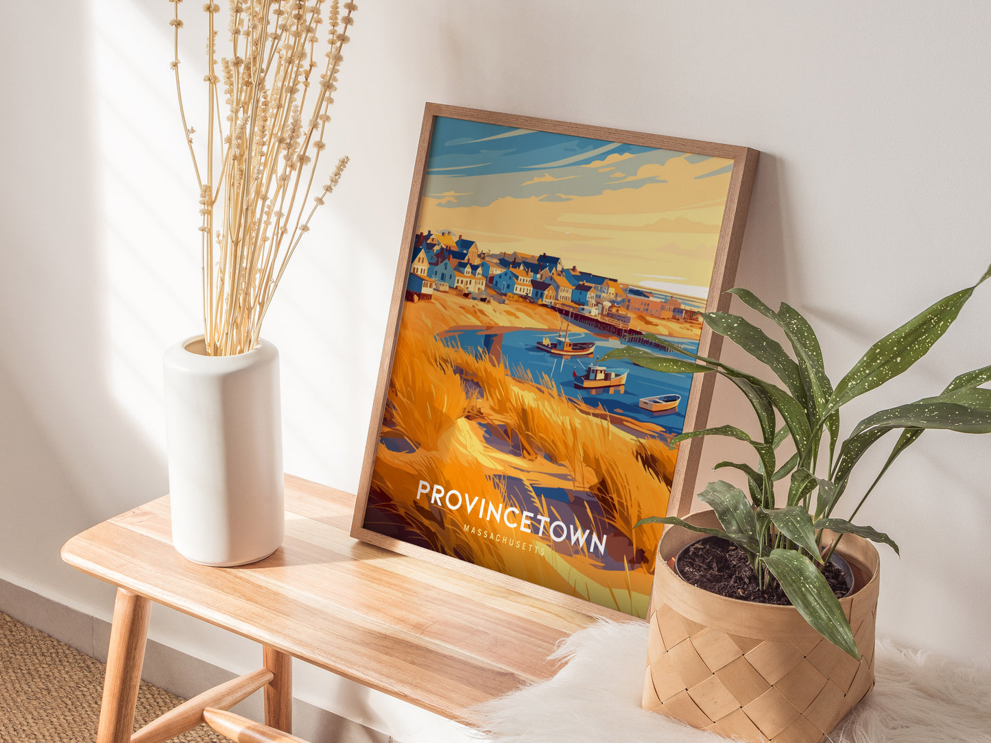 Framed retro travel print of Provincetown, showcasing vibrant houses, boats in the harbor, and golden sandy dunes.