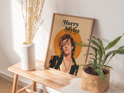 A framed Harry Styles poster with an orange circle background sits on a wooden bench, alongside a white vase with dried flowers and a potted green plant.