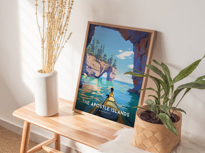 Framed Apostle Islands poster featuring a vibrant kayak scene with turquoise waters, rocky cliffs, and a clear sky, perfect for travel art lovers.