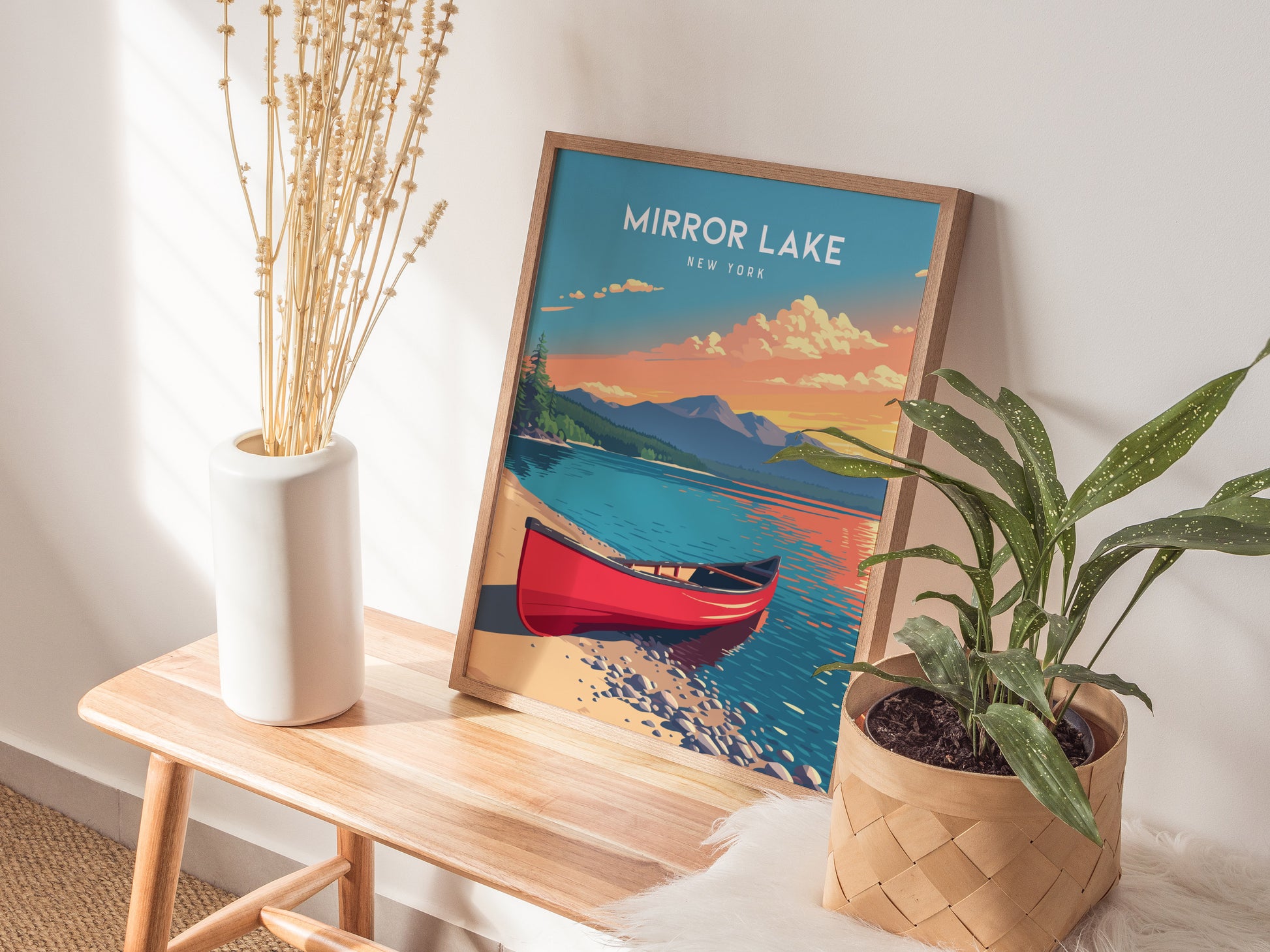 A vibrant poster of Mirror Lake, New York, features a red canoe on calm waters, surrounded by lush greenery and distant mountains under a colorful sunset.