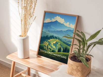 A framed Santa Cruz Mountains poster rests on a wooden bench beside a white vase with dried stems and a potted green plant. Sunlight casts soft shadows on the wall.
