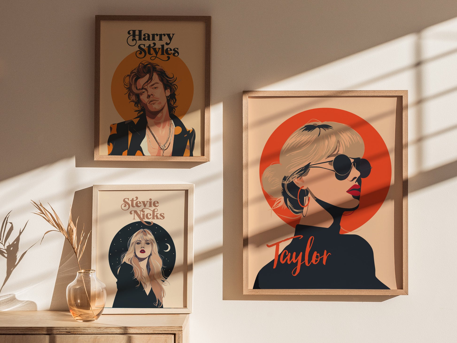 Three framed posters are displayed on a wall. The posters feature stylized illustrations of Harry Styles, Stevie Nicks, and Taylor Swift, each with unique artistic designs and colors.