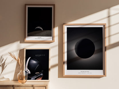 Framed solar eclipse wall art featuring the moon silhouetted against a glowing corona, set in a starry night sky, celebrating Artemis II.