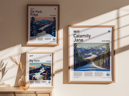 Three framed posters on a sunlit wall depict ski runs at Big Sky, Montana, including Calamity Jane, Elk Park Ridge, and Big Horn, with scenic mountain landscapes.