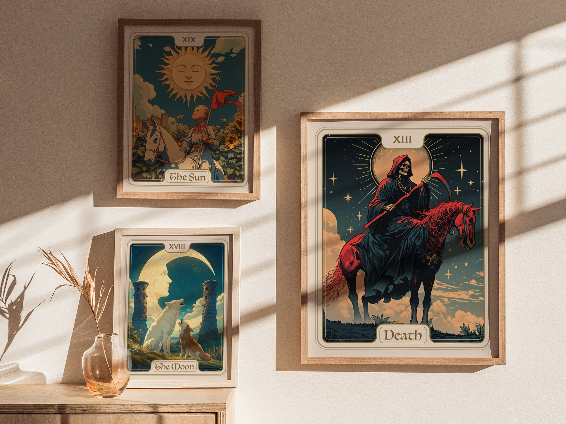Three framed tarot card posters are displayed on a sunlit wall, featuring The Sun, The Moon, and Death, each with vibrant colors and intricate designs.