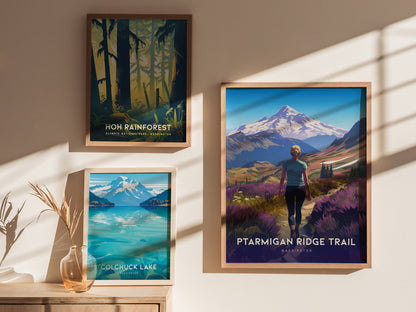 Three framed posters are displayed on a sunlit wall, featuring scenes from Hoh Rainforest, Colchuck Lake, and Ptarmigan Ridge Trail with a hiker and Mt. Baker in the background.