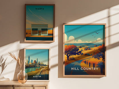 Three framed posters hang on a wall, showcasing scenic views of Marfa, Austin, and Hill Country in Texas. Soft shadows and a vase with dried plants add warmth.