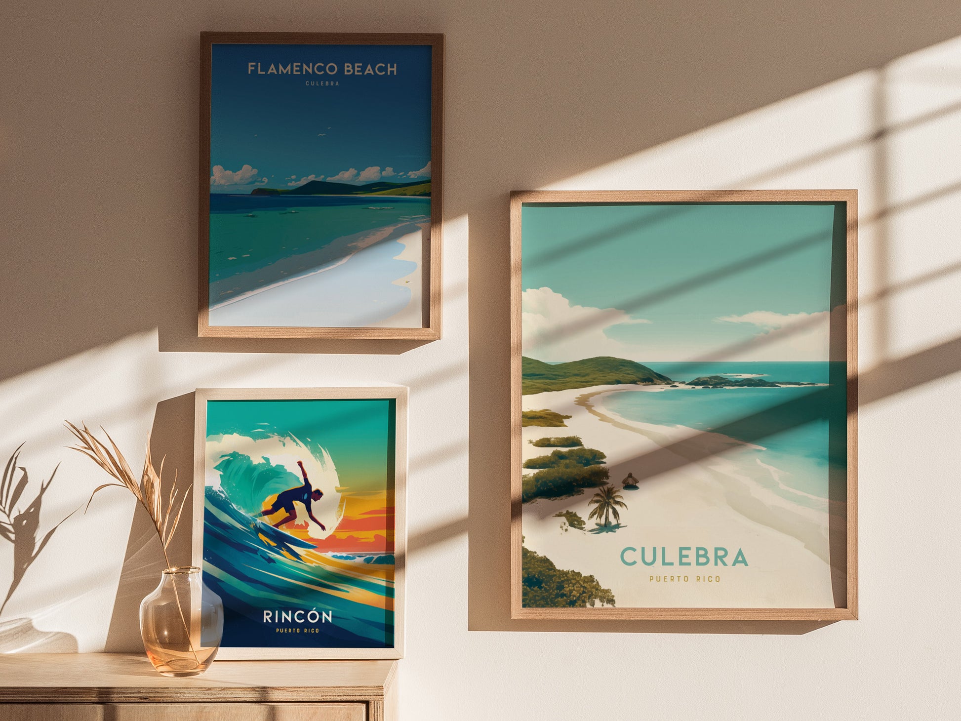 Three framed posters are displayed on a sunlit wall, featuring scenic beach art from Puerto Ricos Flamenco Beach, Culebra, and a surfing scene in Rincón.