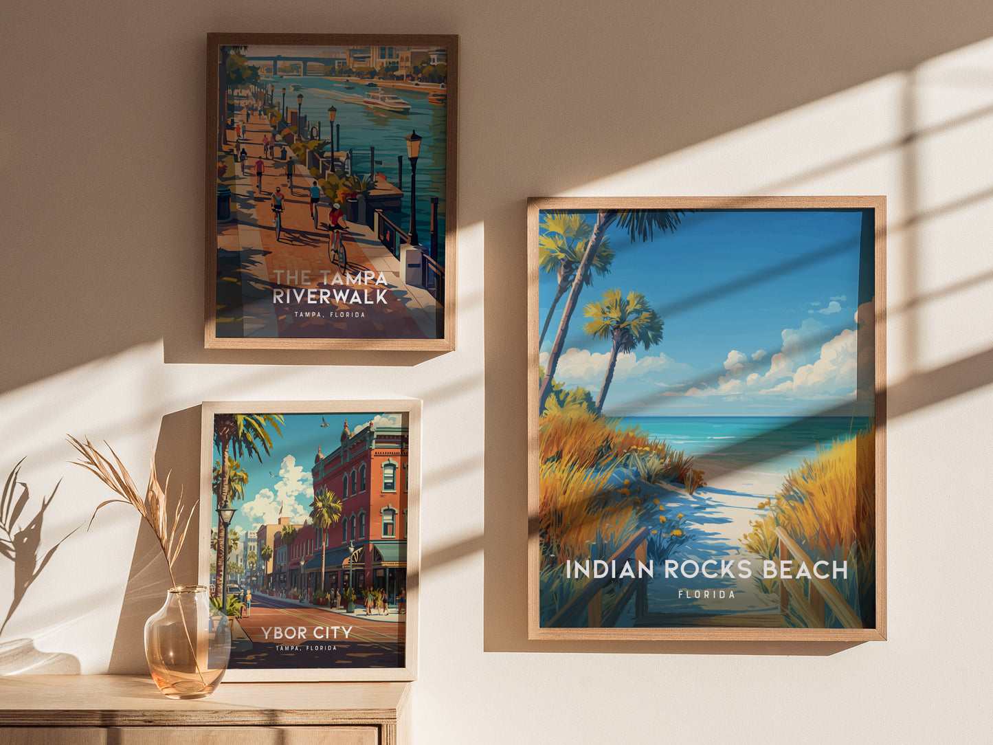 Living space with framed and unframed wall art depicting a tranquil boardwalk and golden sea oats at Indian Rocks Beach.