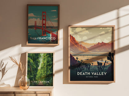 Three framed art prints are displayed on a sunlit wall: San Francisco, Fern Canyon, and Death Valley National Park, each depicting iconic landscapes with vibrant colors.