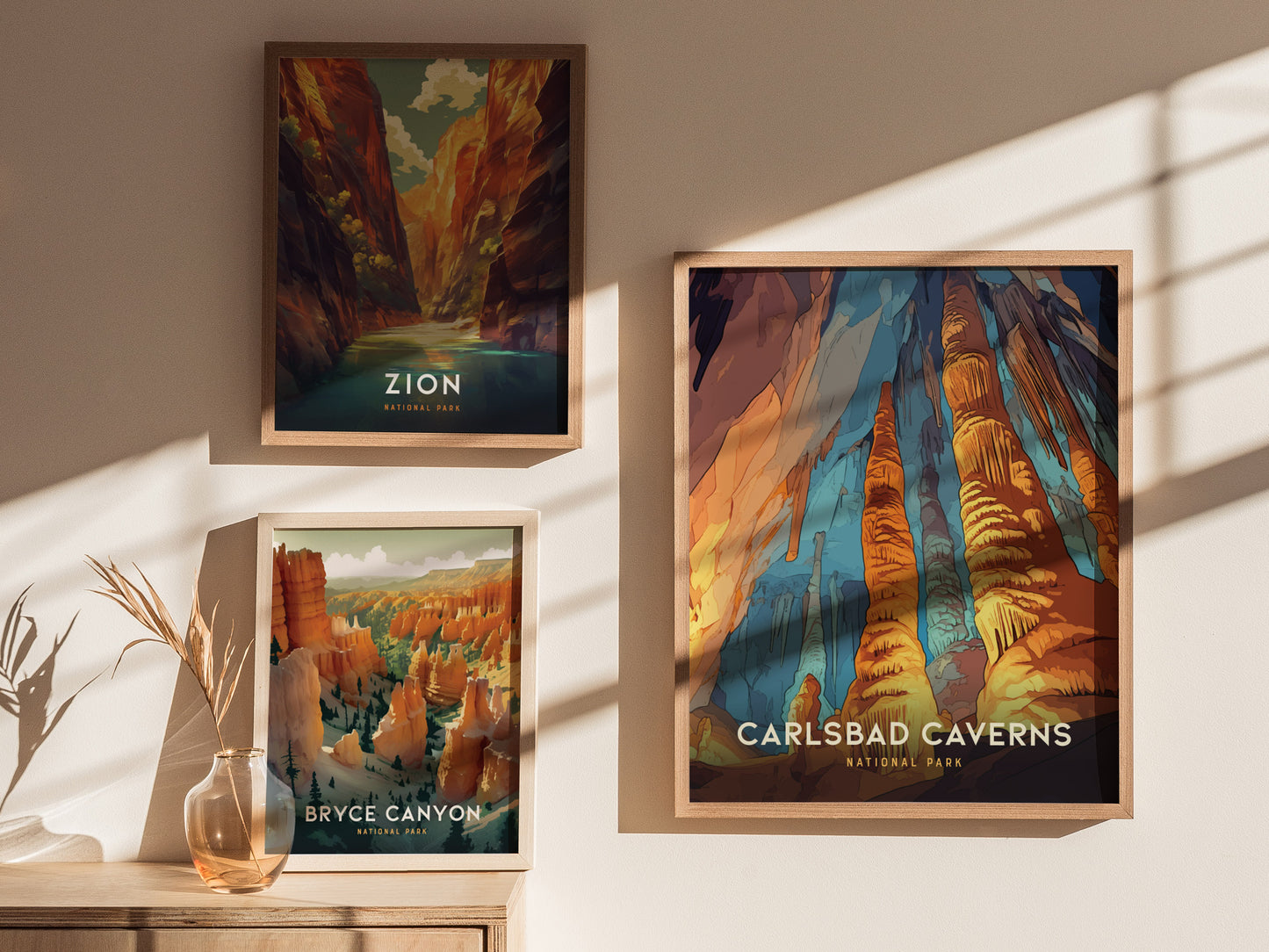 Three framed posters of national parks are displayed on a sunlit wall, featuring Zion, Bryce Canyon, and Carlsbad Caverns with vibrant, colorful landscapes.